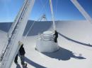 The group at the vertex of the reflector. I'm inspecting the feeds (those round conical things) for ice buildup. Contrary to popular belief, the feedhorn table doesn't move. Rather, a reflector at the focal point points the beam to the desired feed. [Sterling Coffey, N0SSC, photo]