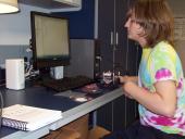 A student working at a computer setup.