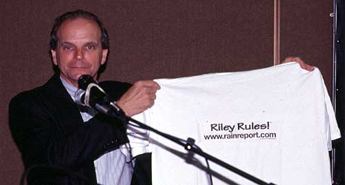 The FCC's Riley Hollingsworth, K4ZDH, holds up a "Riley Rules" T-shirt presented to him at the Dayton Hamvention by Amateur Radio newsman Hap Holly, KC9RP, of the RAIN Report.