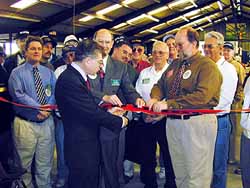 ARRL First VP Steve Mendelsohn, W2ML, (center, in dark suit), cuts the ribbon to inaugurate the West Central Florida section.